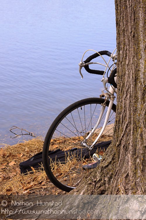 A bike peeks from around the corner near Lake of the Isles.